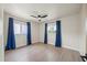 Well-lit bedroom with new floors, two large windows, and modern blue curtains at 6875 11Th N Ave, St Petersburg, FL 33710