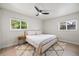 Light-filled main bedroom with a decorative rug and large windows overlooking the backyard at 6875 11Th N Ave, St Petersburg, FL 33710