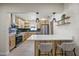 Modern kitchen features stainless steel appliances, light wood cabinets, and bar seating at 6875 11Th N Ave, St Petersburg, FL 33710