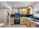 Updated kitchen showcases modern stainless-steel appliances and stylish green backsplash at 6875 11Th N Ave, St Petersburg, FL 33710