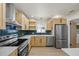 Bright kitchen boasts stainless steel appliances and modern light fixtures at 6875 11Th N Ave, St Petersburg, FL 33710