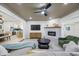 Open-concept living room showcasing a brick fireplace and modern ceiling fan at 6875 11Th N Ave, St Petersburg, FL 33710