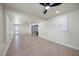 Open living room boasts modern wood-look floors, ceiling fans, and natural light at 6875 11Th N Ave, St Petersburg, FL 33710