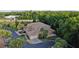 Aerial view of a tan townhome surrounded by lush, mature trees and landscaping at 7246 Gaberia Rd, New Port Richey, FL 34655