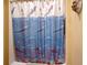 Bathroom featuring a dolphin-themed shower curtain at 7246 Gaberia Rd, New Port Richey, FL 34655