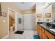 Well-lit bathroom featuring a glass-enclosed shower, granite countertops, and double sink vanity at 7246 Gaberia Rd, New Port Richey, FL 34655