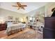 Cozy bedroom featuring a decorative ceiling fan, plush carpet, and natural light from the window at 7246 Gaberia Rd, New Port Richey, FL 34655