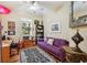 Cozy bedroom featuring natural light, a comfortable purple sofa, and a stylish black-and-white area rug at 7246 Gaberia Rd, New Port Richey, FL 34655