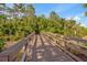 Scenic wooden boardwalk lined with stainless steel railings provides access to tranquil nature trails at 7246 Gaberia Rd, New Port Richey, FL 34655