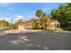 Exterior view of a home with a tile roof, two-car garage, and tropical landscaping at 7246 Gaberia Rd, New Port Richey, FL 34655