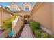Charming front entrance with brick walkway and lush tropical plants at 7246 Gaberia Rd, New Port Richey, FL 34655