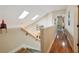 Bright hallway with hardwood floors, skylights, and access to multiple rooms at 7246 Gaberia Rd, New Port Richey, FL 34655