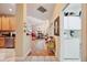 Inviting hallway with hardwood floors leading to the kitchen and dining area, plus laundry room access at 7246 Gaberia Rd, New Port Richey, FL 34655