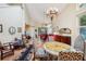 Spacious living room featuring high ceilings, hardwood floors, chandelier, and stylish furnishings at 7246 Gaberia Rd, New Port Richey, FL 34655