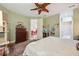 Bright and airy main bedroom boasting a decorative ceiling fan and an en-suite bathroom at 7246 Gaberia Rd, New Port Richey, FL 34655