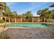 Resort-style pool with covered lounge areas, palm trees, and paved deck is perfect for relaxing and entertaining at 7246 Gaberia Rd, New Port Richey, FL 34655