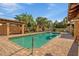 Community pool with covered lounge areas, palm trees, and brick paver surround is a great place to cool off at 7246 Gaberia Rd, New Port Richey, FL 34655