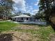 Large backyard featuring a new patio and screened in pool with fresh landscaping at 7278 Radcliff St, Spring Hill, FL 34606