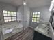 Bathroom with updated tub, vanity and floors with plentiful natural light at 7278 Radcliff St, Spring Hill, FL 34606