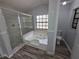 Bathroom with updated spa tub, shower and modern fixtures at 7278 Radcliff St, Spring Hill, FL 34606