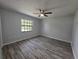 Bedroom featuring updated flooring, neutral paint, and a ceiling fan at 7278 Radcliff St, Spring Hill, FL 34606