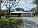 Charming single-story home with a well-manicured lawn, grey exterior, and an attached two-car garage at 7278 Radcliff St, Spring Hill, FL 34606