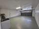 Spacious two car garage with utility sink and access door at 7278 Radcliff St, Spring Hill, FL 34606