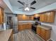 Modern kitchen with stainless steel appliances, wooden cabinets and granite counters at 7278 Radcliff St, Spring Hill, FL 34606