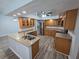 Bright kitchen featuring wooden cabinets, island, stainless steel appliances and hardwood floors at 7278 Radcliff St, Spring Hill, FL 34606