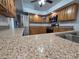 Kitchen highlighting stainless steel appliances, granite countertops, and wooden cabinets at 7278 Radcliff St, Spring Hill, FL 34606