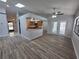 Open living space featuring wood flooring, skylights, and an eat-in kitchen at 7278 Radcliff St, Spring Hill, FL 34606