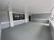 Enclosed patio featuring a neutral paint scheme and a spacious sitting area at 7278 Radcliff St, Spring Hill, FL 34606