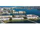 Breathtaking aerial view of waterfront properties with lush landscaping, docks, and a serene bay at 7465 Bay Island S Dr # 213, South Pasadena, FL 33707