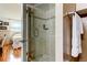 Bathroom showcasing a glass-enclosed shower with tile surround, offering a clean and modern look with a view to the bedroom at 7465 Bay Island S Dr # 213, South Pasadena, FL 33707