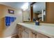 Bathroom featuring a vanity with ample counter space, cabinets, and a large mirror at 7465 Bay Island S Dr # 213, South Pasadena, FL 33707