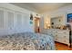 Bedroom features white dresser with mirror, closet and blue floral comforter at 7465 Bay Island S Dr # 213, South Pasadena, FL 33707