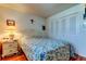 Cozy bedroom with a comfortable bed, a bedside table, and a closet with classic white doors at 7465 Bay Island S Dr # 213, South Pasadena, FL 33707
