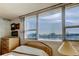 Bright bedroom with a large window providing stunning water views, complemented by classic furnishings and ample natural light at 7465 Bay Island S Dr # 213, South Pasadena, FL 33707