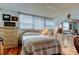 Bright bedroom featuring hardwood floors, natural light, and ample closet space at 7465 Bay Island S Dr # 213, South Pasadena, FL 33707