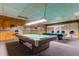 Cozy billiard room with wood paneling, two pool tables, and comfortable seating at 7465 Bay Island S Dr # 213, South Pasadena, FL 33707