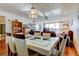 Welcoming dining area featuring an elegant glass-top table with seating for six, complemented by hardwood floors and ample lighting at 7465 Bay Island S Dr # 213, South Pasadena, FL 33707