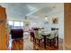 Charming dining area features modern white table, stylish chairs, and views into a cozy living room at 7465 Bay Island S Dr # 213, South Pasadena, FL 33707