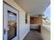 Exterior entryway featuring white door, covered walkway, and tropical landscaping in a residential building at 7465 Bay Island S Dr # 213, South Pasadena, FL 33707