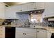 Updated kitchen featuring granite countertops, stainless steel appliances, modern backsplash, and a convenient layout for cooking at 7465 Bay Island S Dr # 213, South Pasadena, FL 33707