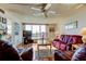 Inviting living room features hardwood floors, large windows offering water views, and a cozy seating area at 7465 Bay Island S Dr # 213, South Pasadena, FL 33707