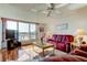 Bright living room with a large window, wood floors, ceiling fan and comfortable seating at 7465 Bay Island S Dr # 213, South Pasadena, FL 33707