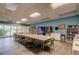 Large recreation room with tables, chairs, and bookshelves, perfect for community gatherings and reading at 7465 Bay Island S Dr # 213, South Pasadena, FL 33707