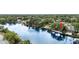 Aerial view of waterfront home with mature trees and well-maintained landscaping at 8203 Kirkwood Dr, Tampa, FL 33634