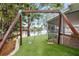 Backyard featuring a swing set, lake view, and manicured lawn at 8203 Kirkwood Dr, Tampa, FL 33634