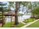 Backyard with a treehouse, lake view, and manicured lawn at 8203 Kirkwood Dr, Tampa, FL 33634